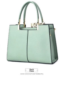 Rear view of mint green lychee pattern tote bag with golden hardware and silk scarf