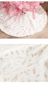 Detailed view of white faux fur Christmas tree skirt with golden feather foil print