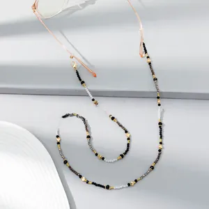 Detail of colorful crystal beaded eyewear chain with gold heart charm and silicone loops