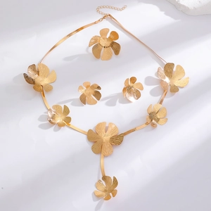 Golden floral jewelry set with brushed texture necklace, ring and earrings on white surface