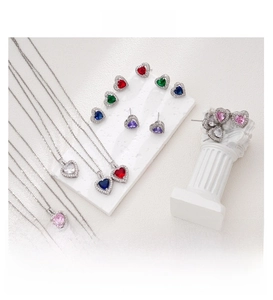 Detailed close-up of heart-shaped zircon necklace and earrings in multiple vibrant colors