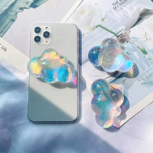 Close-up of holographic cloud phone socket grip attached to a smartphone on a magazine