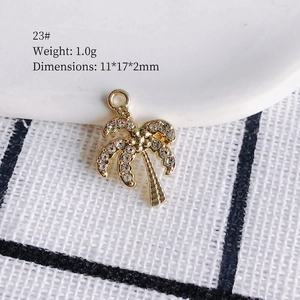 Detailed view of coconut tree pendant with rhinestones measuring 11x17x2mm and weighing 1.0g
