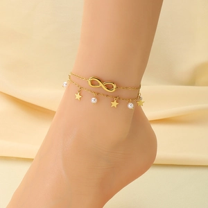 Detail of 18K gold plated double-layer anklet with infinity charm and small star pendant