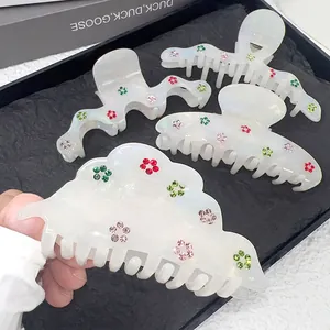 Elegant white acetate hair claw clips set with colorful rhinestone flower patterns