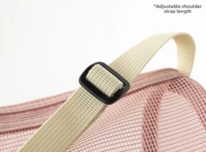 Close-up of pink mesh bag featuring adjustable beige shoulder strap and buckle