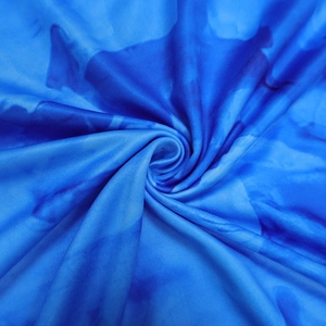 Close-up of blue tie-dye printed fabric showing soft texture and elastic material details