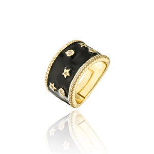 Detailed macro view of wide gold band ring with black enamel, stars and zircon stones
