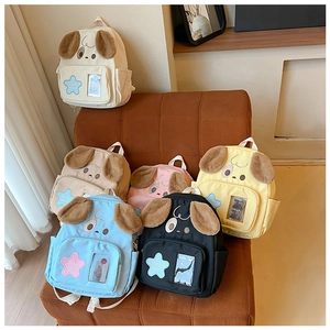 Multiple colors of cute dog canvas backpacks with plush details on a warm indoor sofa