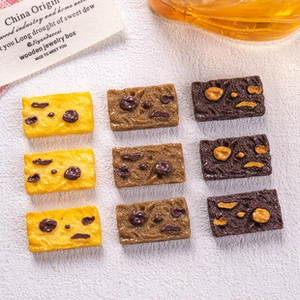 Detailed grid of nine miniature resin cookies in yellow and brown for DIY crafts
