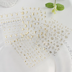 Detail of champagne gold moon star nail stickers on glass tray with C7301-C7303 codes