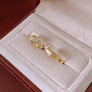 Detail of gold double-layered rectangular hoop earrings with cubic zirconia and shell inlay