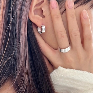 925 sterling silver layered rings and multi-row hoop earrings set shown on a model