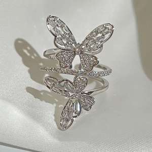 Elegant silver butterfly ring with sparkling cubic zirconia on white silk background