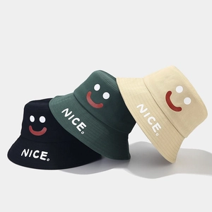 Smiley face bucket hats in black, dark green and beige with NICE text embroidery
