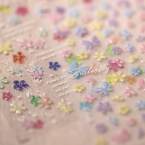 3D embossed nail stickers featuring macaron floral and butterfly designs on beige background