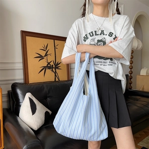 Detailed texture of blue striped canvas tote bag with seersucker fabric finish