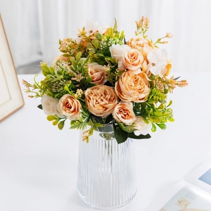 Close-up of artificial champagne peonies in a ribbed glass vase for home decor