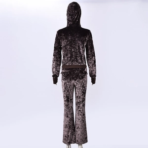 Back view of brown velvet tracksuit featuring hooded sweatshirt and flared pants detail