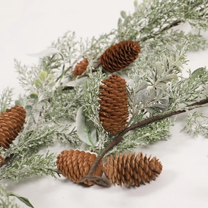 Snowy Christmas garland with pine cones and frosted needles on white background