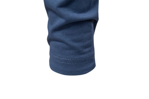 Detailed close-up of double-stitched cuffs on a blue business casual long sleeve shirt
