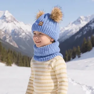 Light blue kids winter knit hat with double pom poms and matching neck warmer set