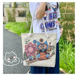 Detail of floral owl jacquard canvas tote bag with cotton rope handles in outdoor setting