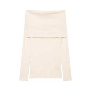 Close-up of cream off-shoulder knitted top showing ribbed texture and elastic slim fit