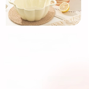 Macro shot of pumpkin-shaped ceramic bowl with double handles for microwave and oven use