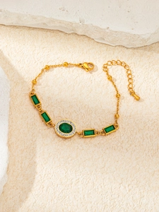 Detail of gold titanium bracelet with emerald zircon stars and adjustable clasp