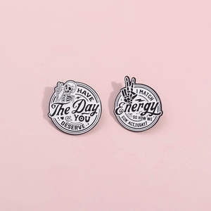 Gothic skull enamel pins with humorous slogans Have the Day You Deserve and Match Energy
