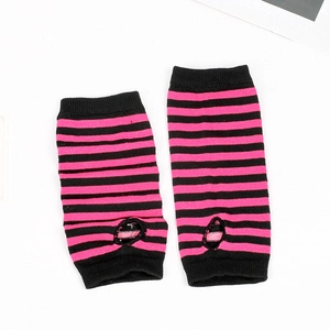 Detail of pink and black striped knit fingerless gloves with thumb hole for punk style