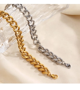 Detail of gold and silver cuban link bracelets with secure lobster clasps in polished steel
