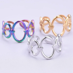 Close-up of three colorful rainbow, gold, and silver chain link adjustable rings