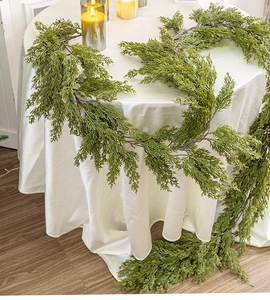 Close-up of artificial cypress garland with realistic green needle texture for tables