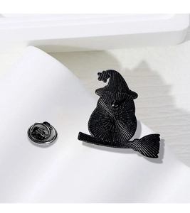 Detail view of the black alloy badge back with silver butterfly clasp and waffle texture