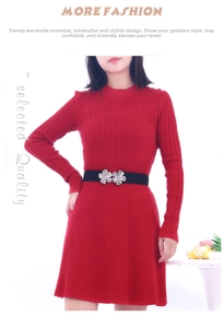 Close-up of black wide waist belt with silver floral buckle on red knitted dress