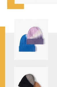 Close-up of chunky cable knit beanie showing colorful tie-dye gradient and thick cuff texture