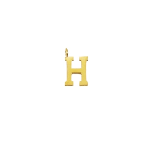Close-up of golden letter H pendant with top loop for DIY jewelry making and necklaces