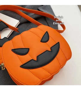 Close-up of Halloween pumpkin crossbody bag featuring orange textured faux leather and gold zipper