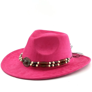Detail of rose red cowboy hat with ethnic beaded band and metallic medallion accent