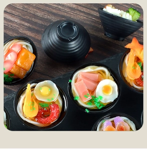 Macro view of miniature ramen food models with detailed resin noodles and tiny ingredients