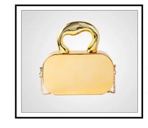 Detailed view of a gold acrylic mirror box bag with a curved handle and fine chain strap
