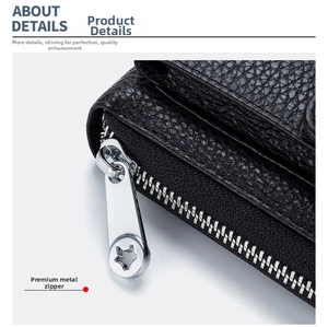 Close-up of black lychee leather bag featuring a silver star-shaped metal zipper puller