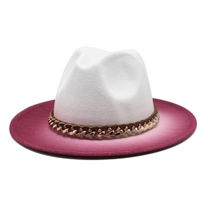 Detail of white wool jazz hat with fuchsia gradient brim and golden chain strap