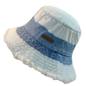 Blue and white gradient denim bucket hat with frayed edges for sun protection