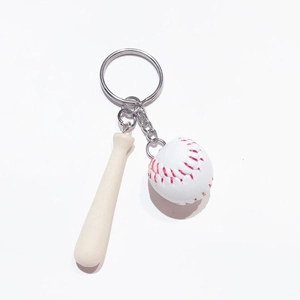 Detail of mini wooden baseball bat and white softball pendant on a metal keychain ring