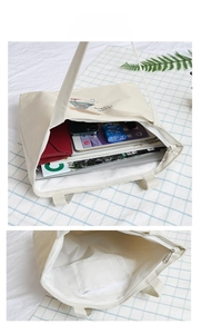 Detail view of canvas tote bag interior showing capacity for iPad and accessories