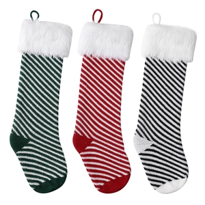 Plush Christmas stockings with knit stripes and white faux fur trim in red green black