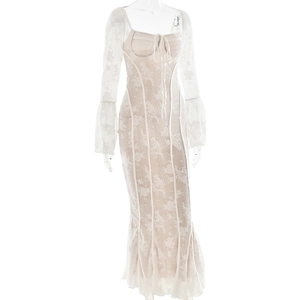 Detail of beige lace dress featuring flared sleeves, ruffled texture and front ribbon tie